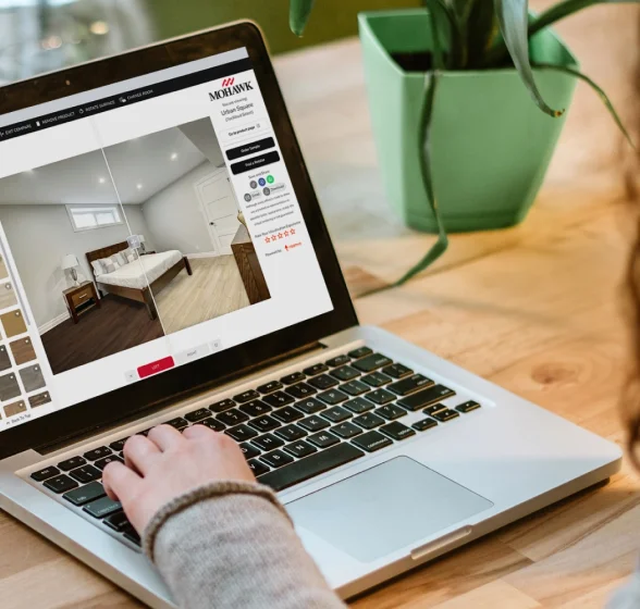 Woman using the state of the art Roomvo room visualizer to complete a flooring project.